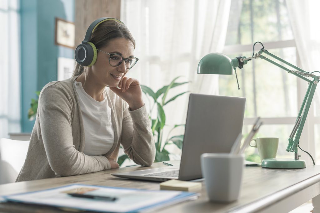 A pretty woman at her desk taking an elearning course